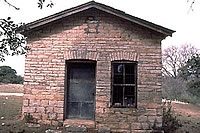 The southeast side of the building was the more ornamented, with lintels over the door and window. During the 1880s, this side was likely the front door. Although the road has now been moved, an aerial map from the 1930s shows the faint traces of an old road winding past this side of the building and on throughout the Barton Creek community. Photo by Tom Hester.