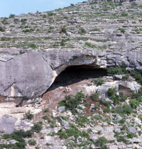 General view of cave and excavations from across canyon