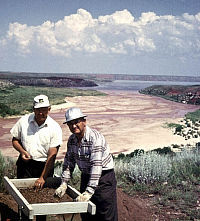 Photo of two men with dry creek bed behind them