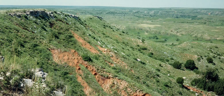 Red hillslopes at the Alibates Flint Quarry National monument only hint at the brilliant colors of the stones contained within. Photo by May Schmidt. 