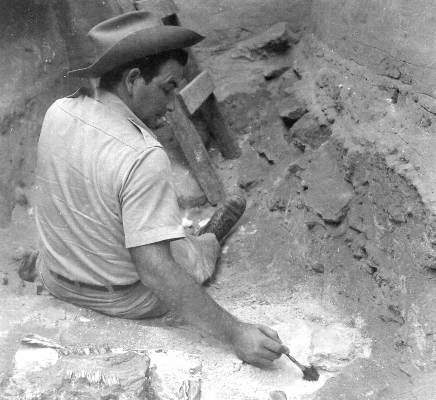 Elton Prewitt cleans the fragments of bison bone discovered in the excavation unit