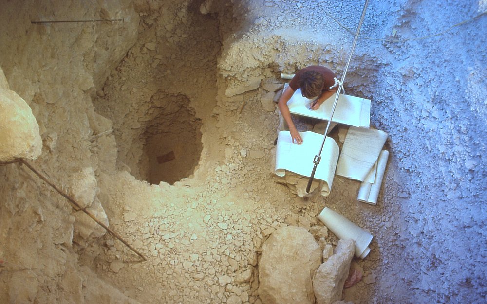 Lee Bement takes final notes at the end of the 1984 season. The small hole on the left is the pit dug in an attempt to reach rock bottom. Photo by Jack Skiles.