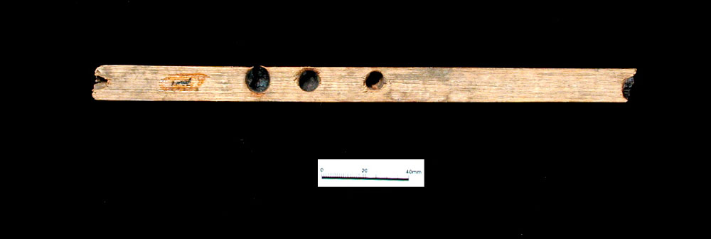 A yucca- or sotol-cane "fire-hearth" with drill holes for fire-starting. A small piece of cane or wood would have been rapidly twisted in one of the holes causing intense friction and gradual buildup of heat. Once a spark was emitted, it would be caught in a wad of tinder such as dried grass, brought to flame, and with added kindling and fuel, a fire would be made.