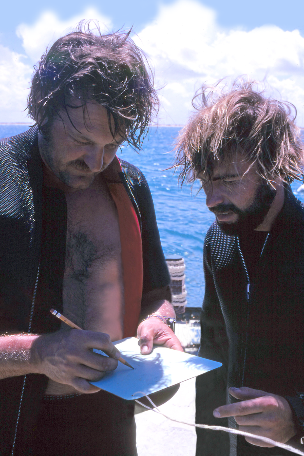 photo of two men confering on a ship deck