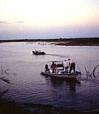 Crews of archeologists and other concerned volunteers set off in early morning hours to begin emergency assessment of sites and structures exposed by the receding waters of Falcon Reservoir in 1996. Both wave action and looters continue to damage the sites. Photo by Tom Hester. 