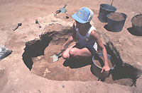 Extramural or outside features were quite common and varied. This is an example of one of the more common features, a probable storage pit later filled with trash. Jeanine Collins is the excavator.