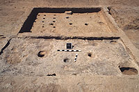 In the foreground is Room 3, a small room on the north side of Room 1 that had a hearth, two postholes, and various floor pits. This room probably served a more limited range of functions than Room 1 and other habitation rooms. Rooms of this size (7 square meters or less) were probably used for storage. Room 1 is in the background and has an adobe step against its south wall. These were once thought to be altars but are now believed to be nothing more than steps into rooms that were below ground level.