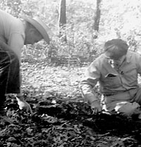 Jay Blaine (left) and King Harris begin a small test pit in a wooded area of the site. Photo by Jerrylee Blaine.