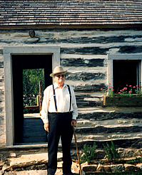 Fred Haas, who grew up in the log house, returns to see the newly restored structure.