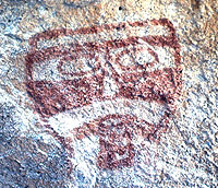 photo of a painted face, or mask, discovered on the wall above a prehistoric water control feature