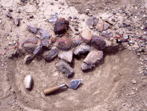 Photo of partially excavated hearth.