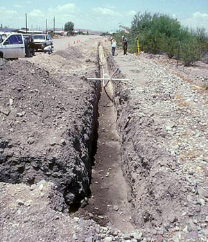 photo of backhoe trench dug  along a roadway