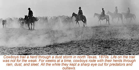 photo of cowboys herding in a dust storm