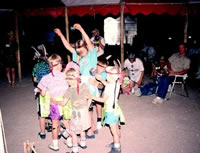 Children perform a dance at evening under the big tent. Photo by Norman Flaigg. 