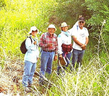 Meanwhile, out in the bushes, a survey crew pauses to pose for photographer E. Mott Davis.