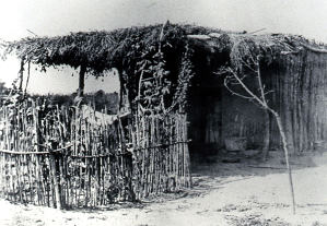 Photograph of a jacal house in El Paso from the late 19th or early 20th century