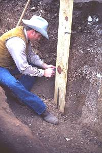 Photo of archeologist Grant Hall preparing a soil monolith.