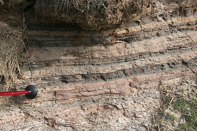 photograph of varved sediment layers in geological exposure
