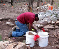 photo of UT-Austin student Felton Pierre excavating the chimney fall rocks 
