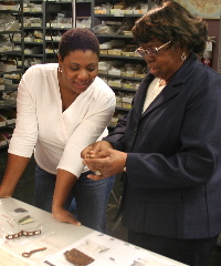 photo of Nedra Lee and Winnie (Harper) Moyer examining artifacts from the Williams farmstead i