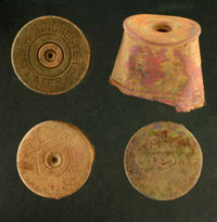 photo of examples of cartridges including 12-gauge shotgun shell heads