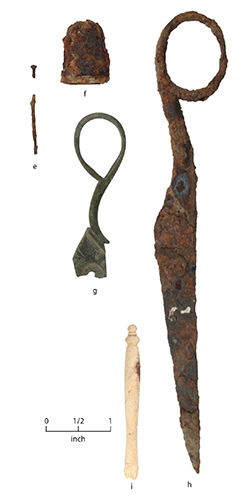 color photo of five fragmented historic artifacts including two rusted scissor handle frags