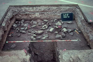 Photo of an excavation uncovering a stone-paved hearth