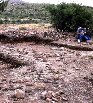 photo of open excavation units full of burned rocks